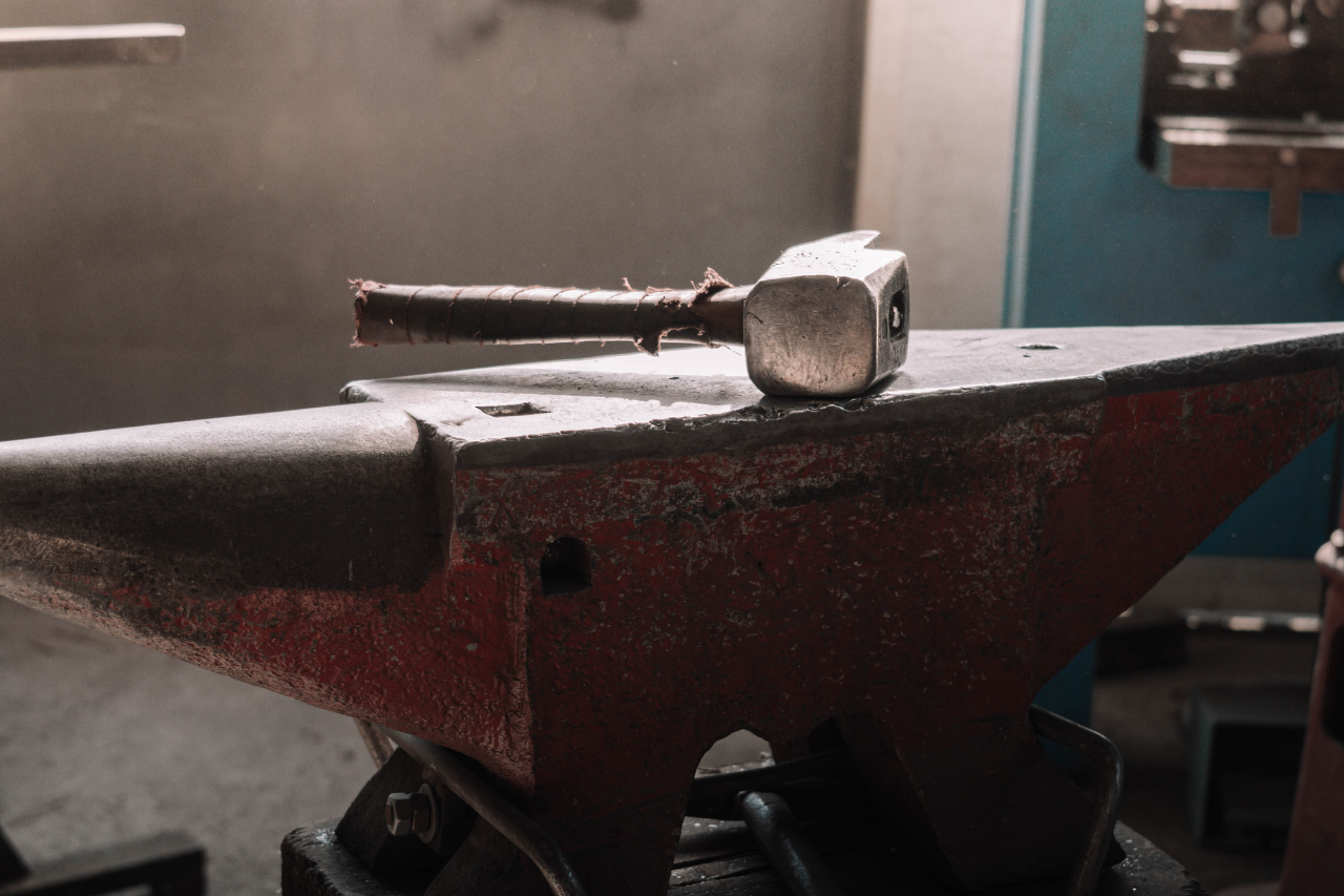 Hammer and anvil in the ironworking workshop where the Hervé Baume collections are handcrafted.