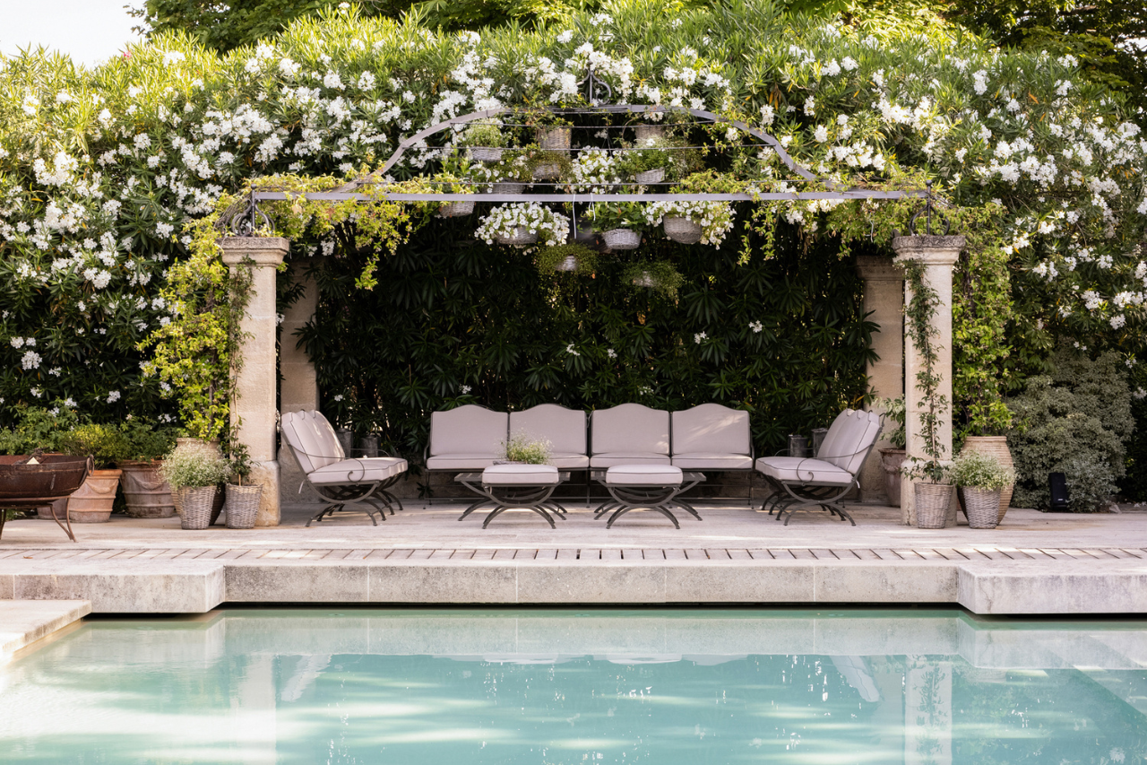 Hervé Baume wrought-iron garden furniture beneath a jasmine-covered pergola, Mas de Chabran.