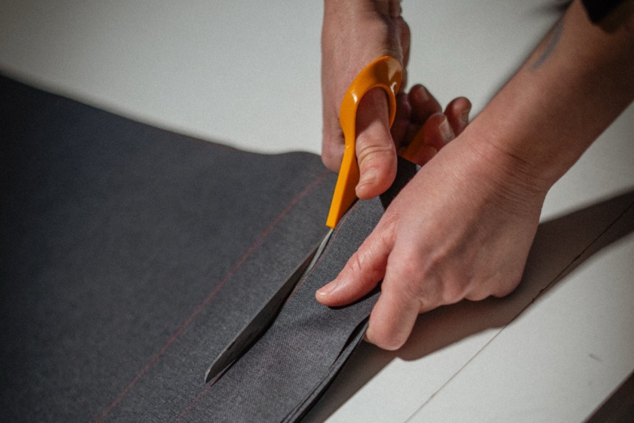 Hand-cutting fabric for the crafting of Hervé Baume outdoor furniture cushions.