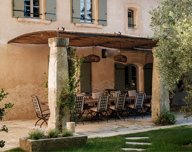 Hervé Baume HB1 Quadrillage Collection wrought-iron dining table beneath a Provençal pergola.