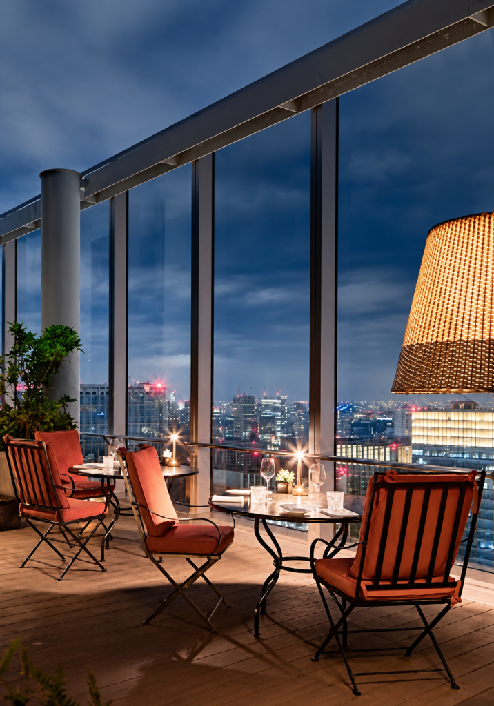 Panoramic views over Tokyo, featuring Hervé Baume HB12 Lattes Collection wrought-iron furniture at Bvlgari Hotel Tokyo.